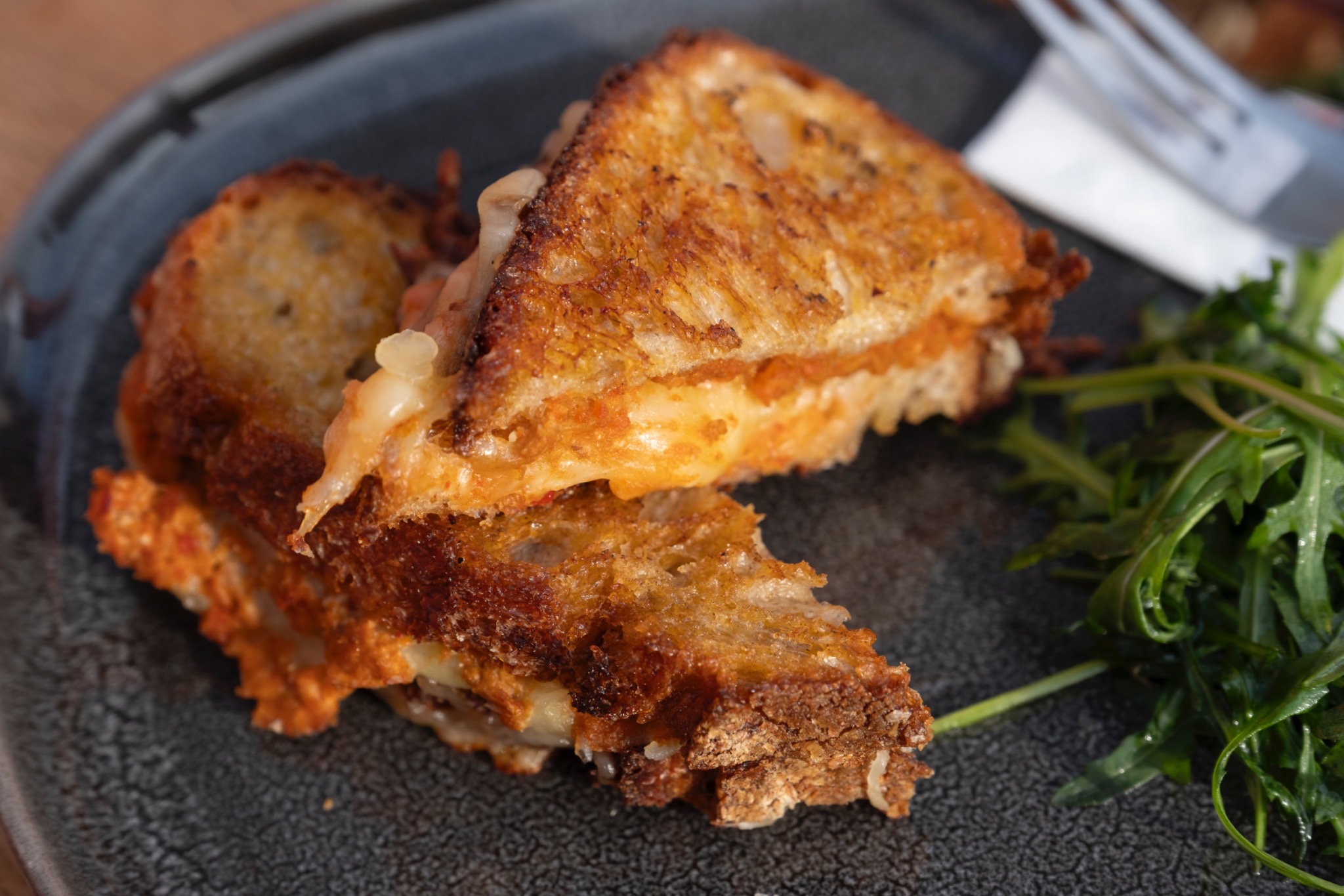 Grilled cheese toastie with rocket salad